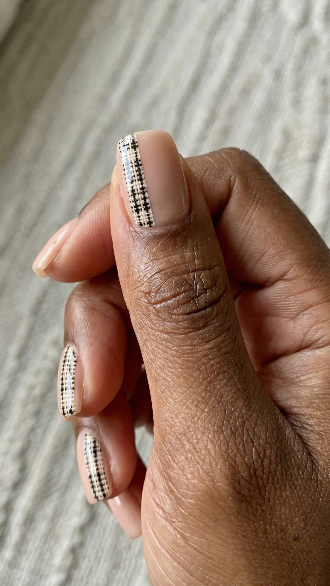 Tweed Side-Stripe — “Short squoval nails with nude base and a single off-center charcoal tweed stripe, glossy finish.”

