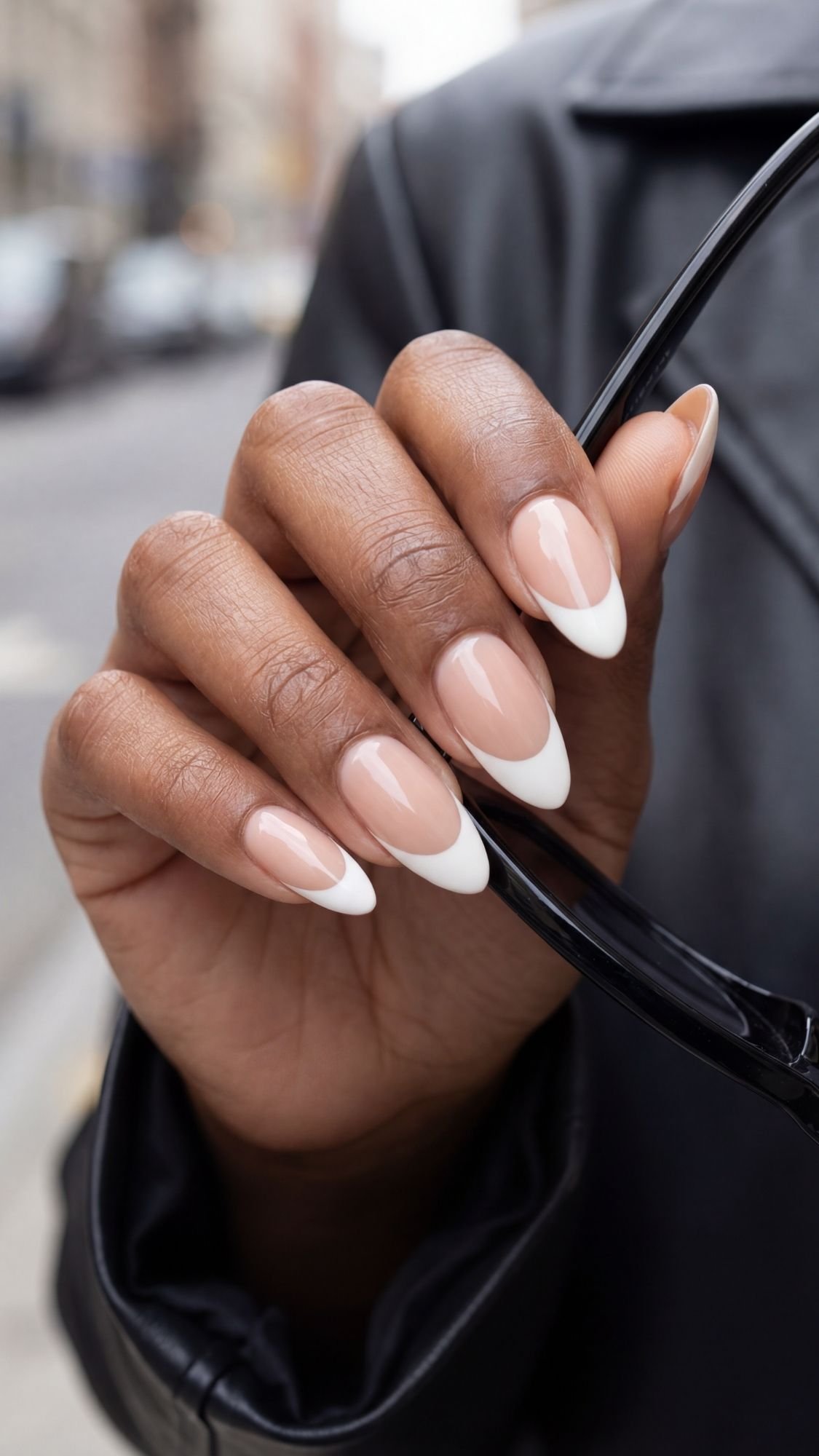 Deep ’90s French Almond Nails — Medium almond nails with a deep, thick white French tip on a nude base.