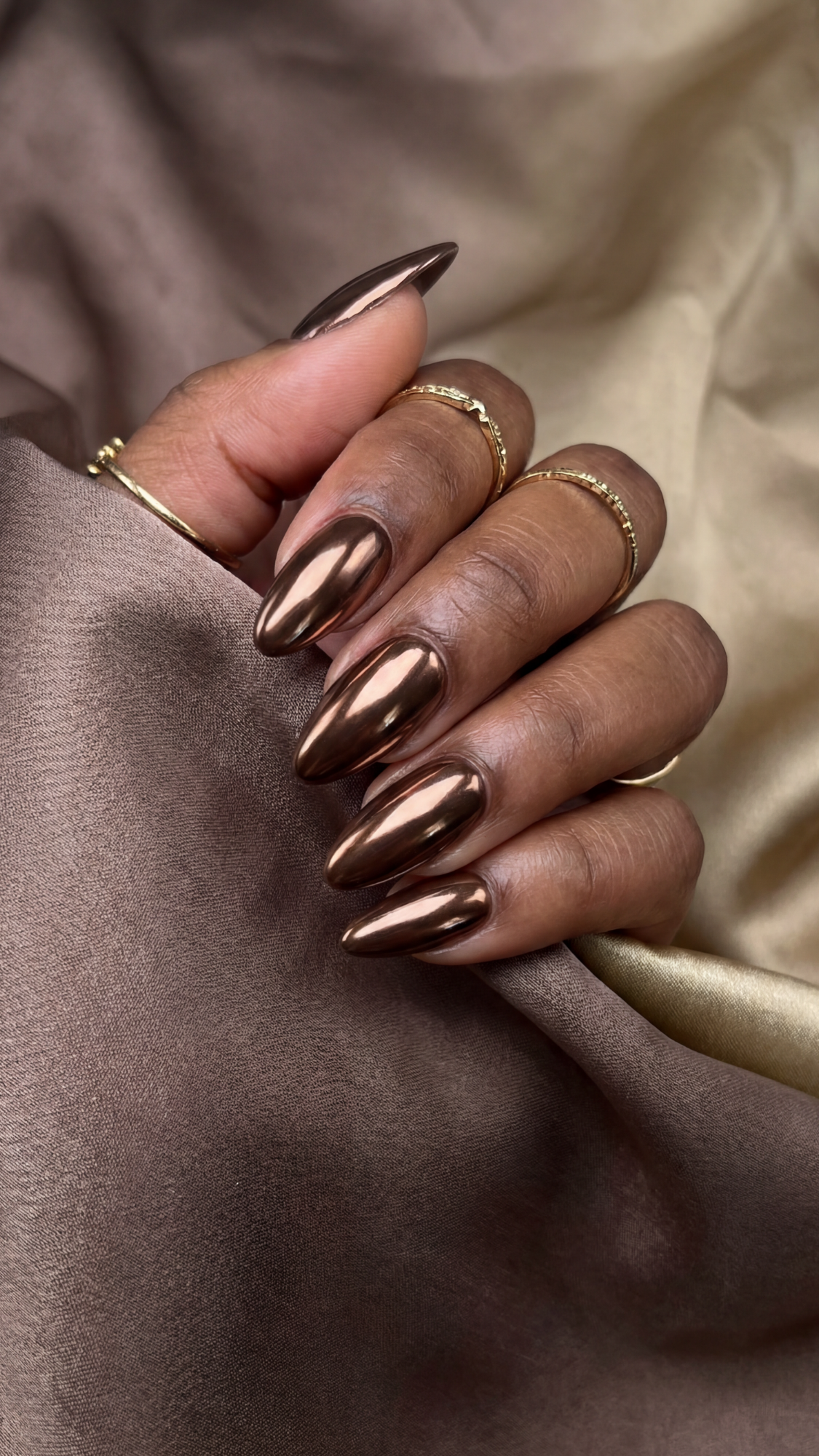 Chocolate Chrome — “Medium almond nails with rich chocolate base and glassy metallic chrome sheen.”
