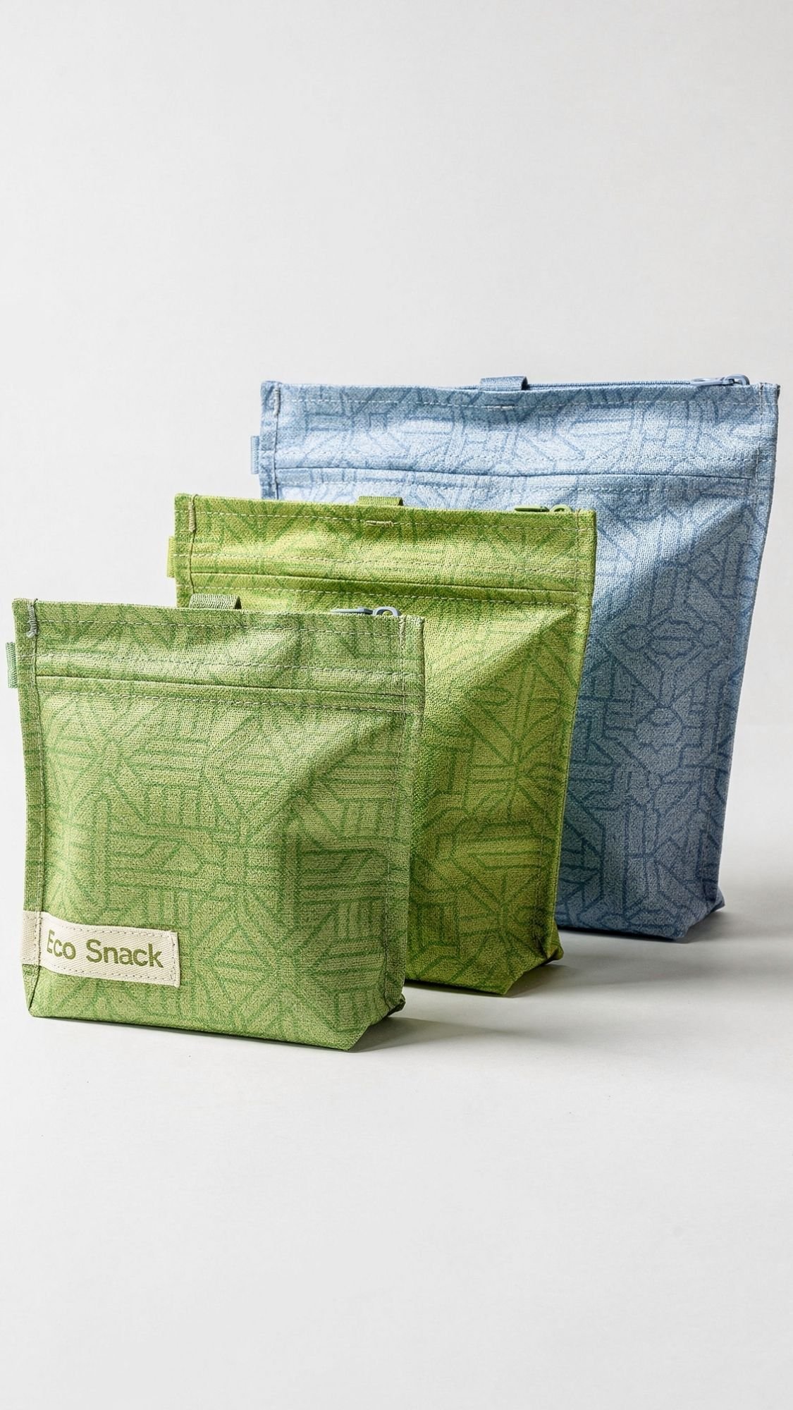 Three reusable fabric snack bags are displayed on a white background. Two are green with geometric patterns, one labeled Eco Snack, and one is light blue with a similar pattern—perfect Handmade Gifts or thoughtful Best Friend Gifts.