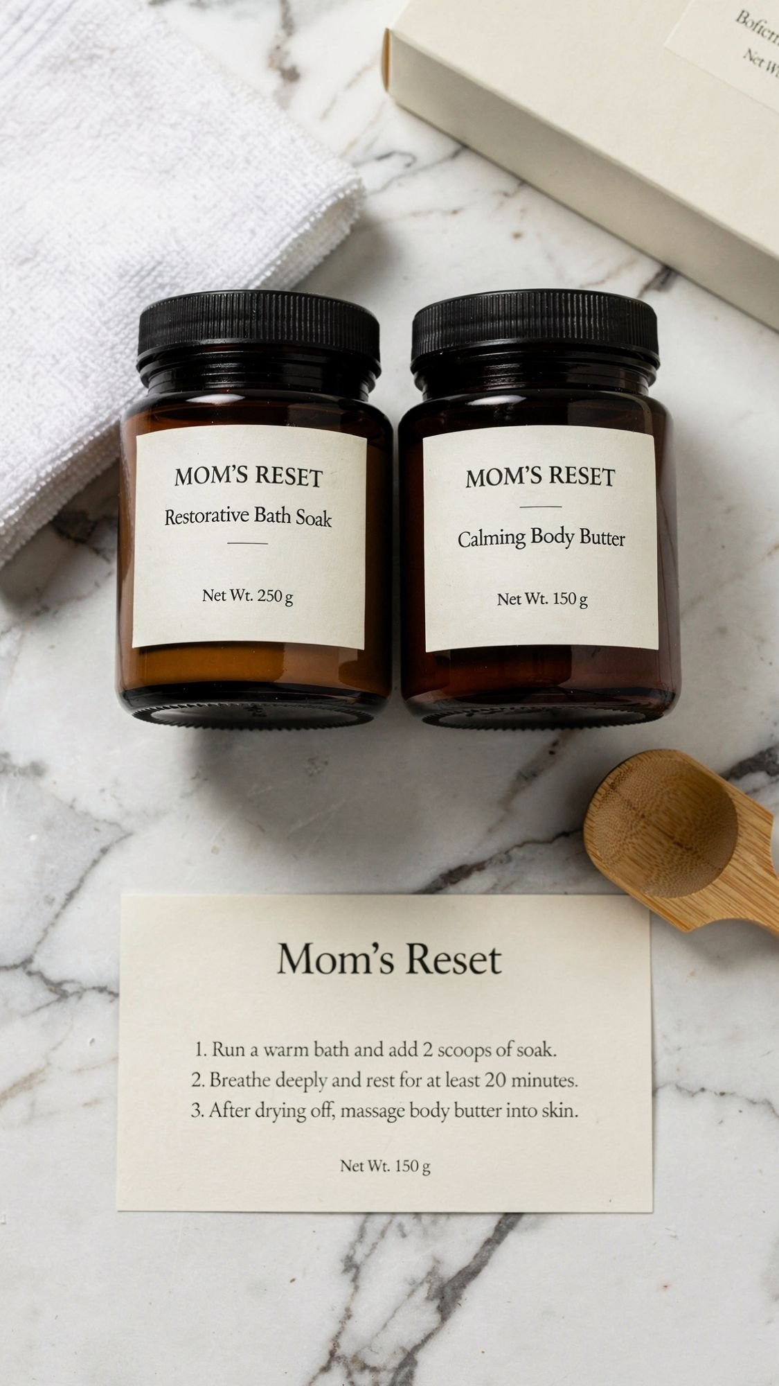 Two brown jars labeled Restorative Bath Soak and Calming Body Butter sit on a marble surface with a towel, wooden scoop, and an instruction card titled Mom’s Reset—perfect for an at home mom spa day or thoughtful DIY presents.